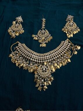 Gold plated heavy jewelry for wedding day. Earrings, side piece and tikka